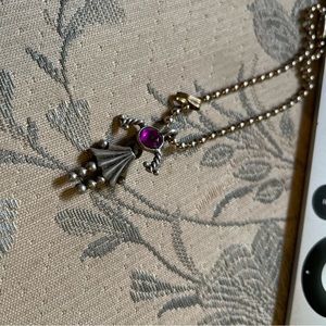 Charm with a pink stone